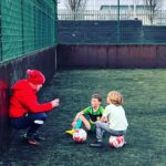 Coaching two young footballers